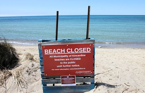 This large red sign indicates that Station Beach, Kincardine, is closed despite the beautiful sunny weather Saturday afternoon