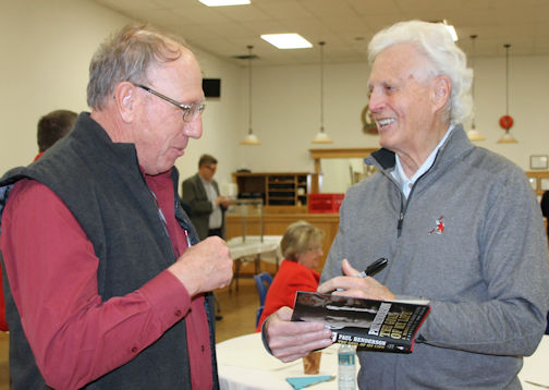 Paul Henderson (right) chats with a fan before signing his book